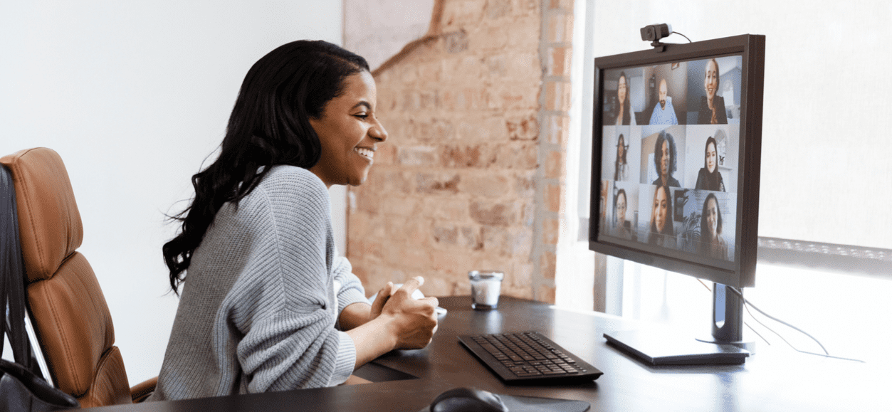 Vrouw in een Zoom-meeting met een grid van internationale collega's — illustratie bij de Europese rollout van Basic-Fit.